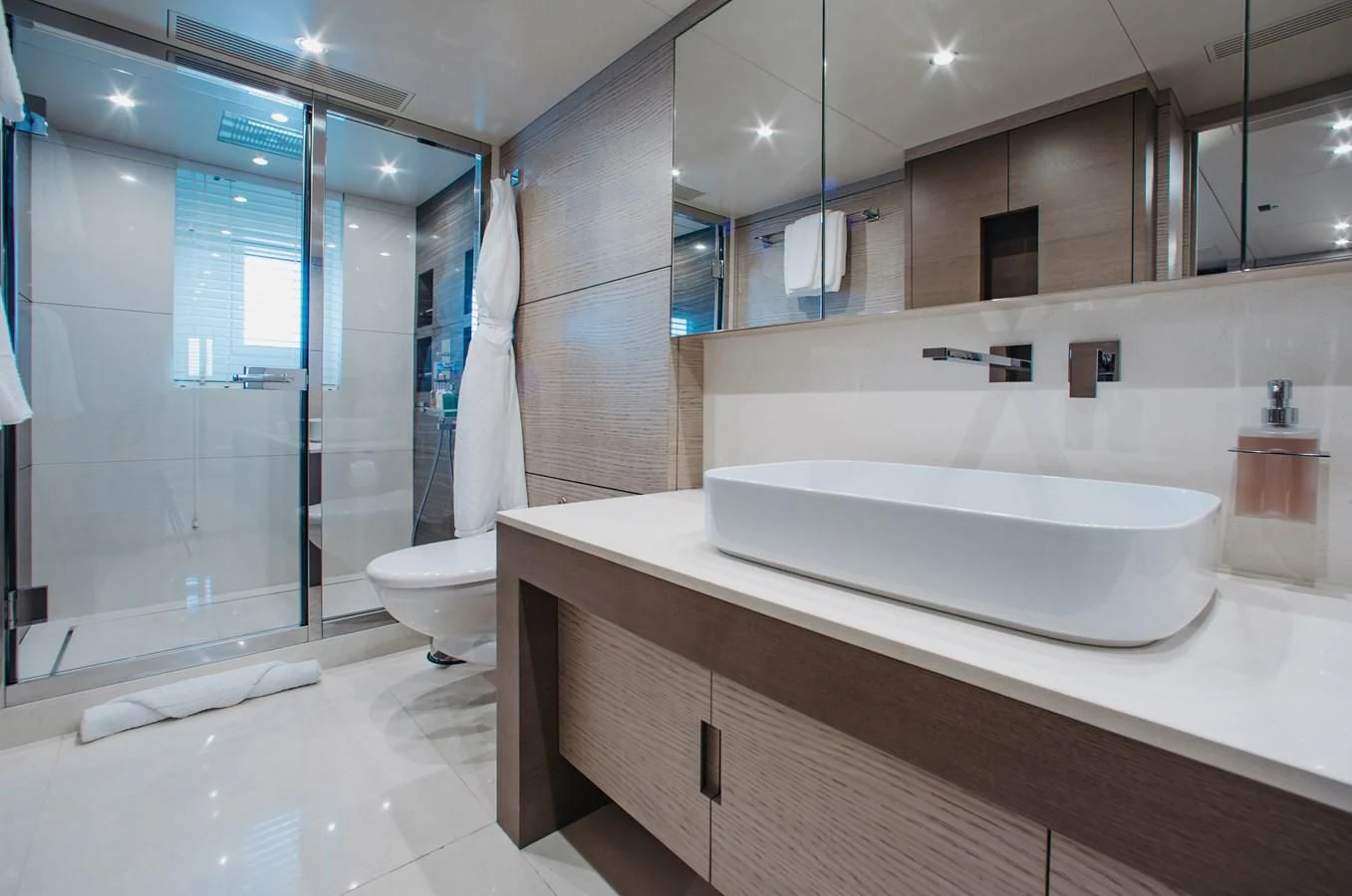a bathroom with a large mirror aboard COFINA Yacht for Sale