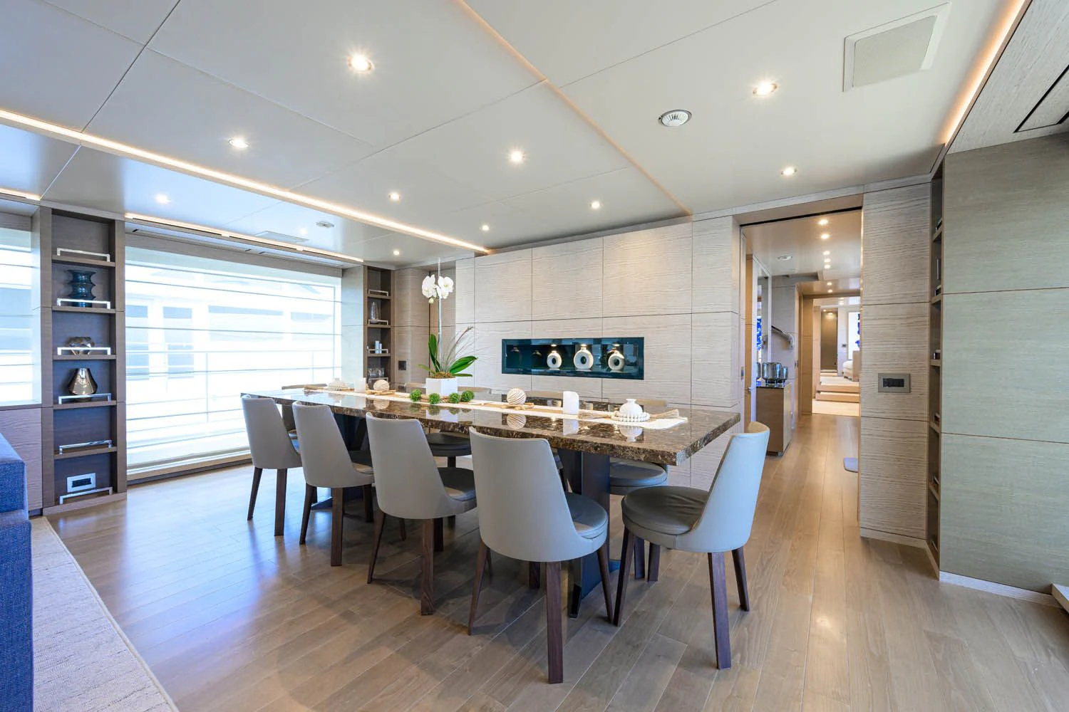 a large kitchen with white chairs aboard COFINA Yacht for Sale