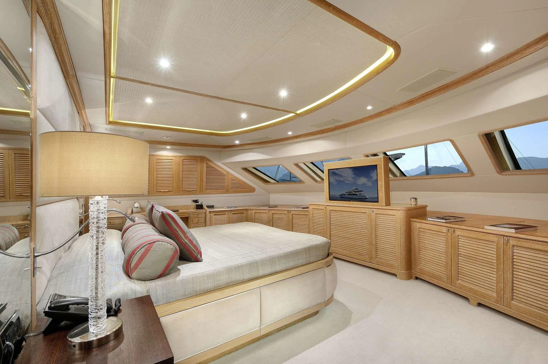 a room with a bed and a lamp aboard QUEST R Yacht for Sale