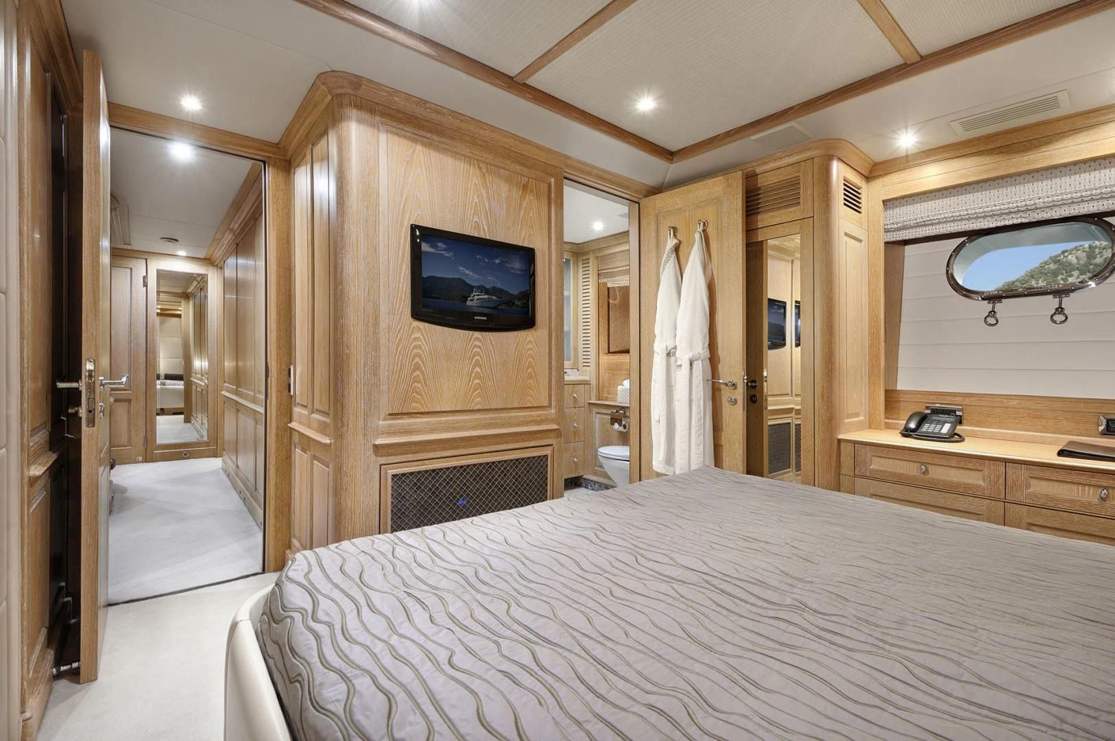 a bedroom with a bed and a television aboard QUEST R Yacht for Sale