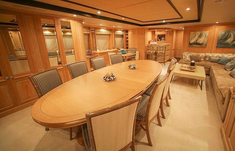 a large room with a table and chairs aboard QUEST R Yacht for Sale