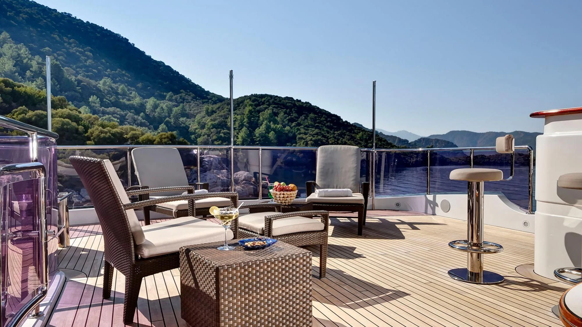 a deck with chairs and tables aboard QUEST R Yacht for Sale