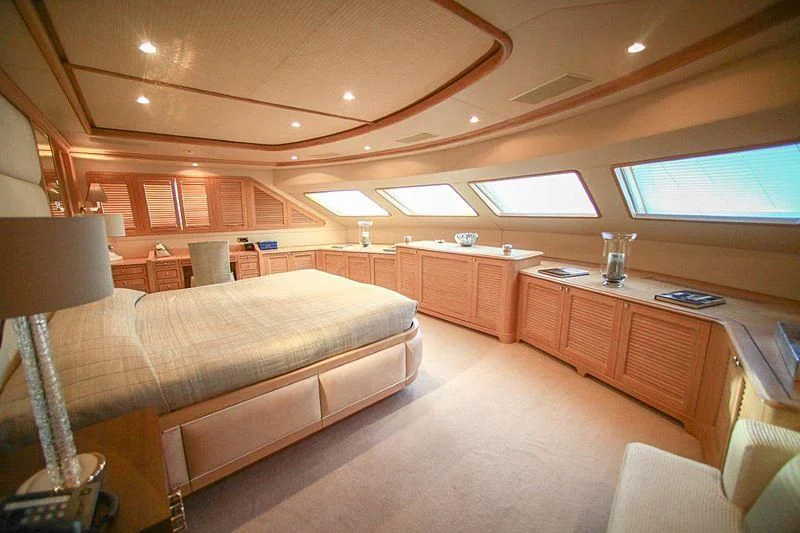 a room with a bed and a desk aboard QUEST R Yacht for Sale