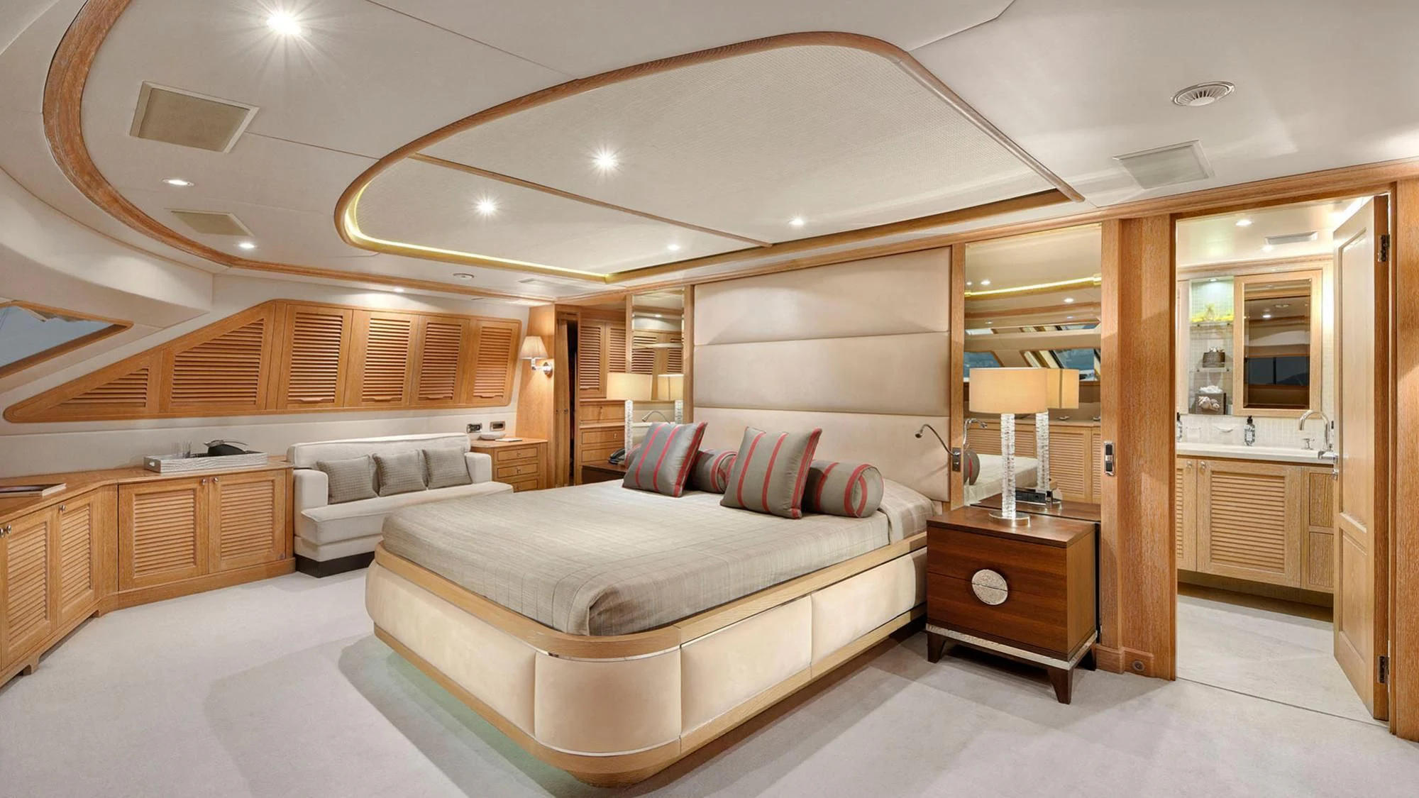 a large room with a bed and a large mirror aboard QUEST R Yacht for Sale