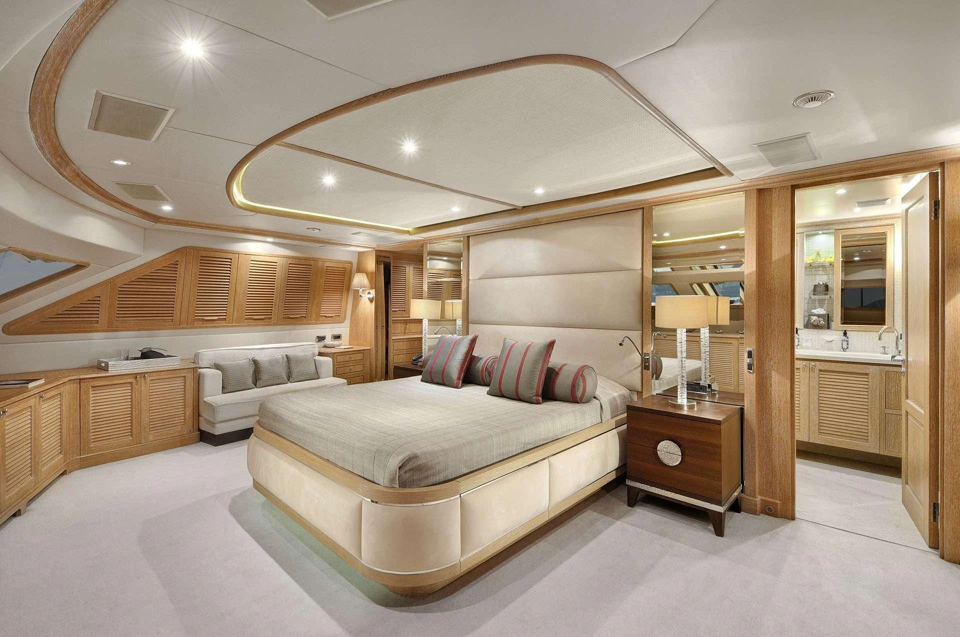 a large room with a bed and a large mirror aboard QUEST R Yacht for Sale