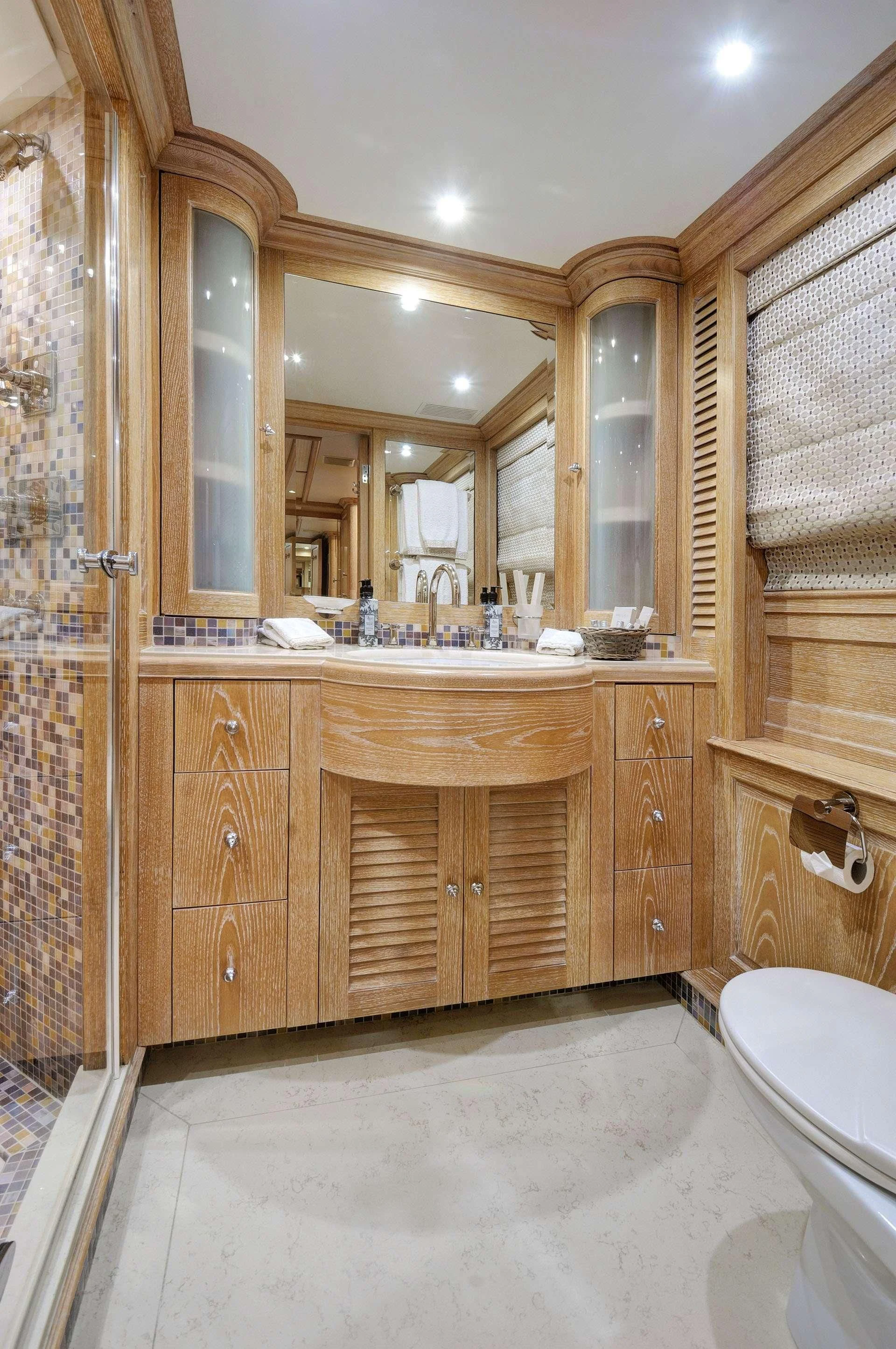a bathroom with a sink and a mirror aboard QUEST R Yacht for Sale