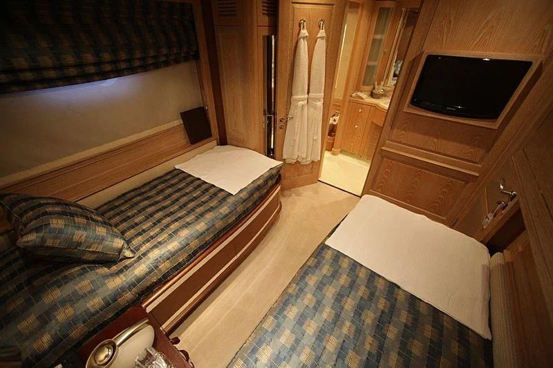 a bedroom with a bed and tv aboard QUEST R Yacht for Sale