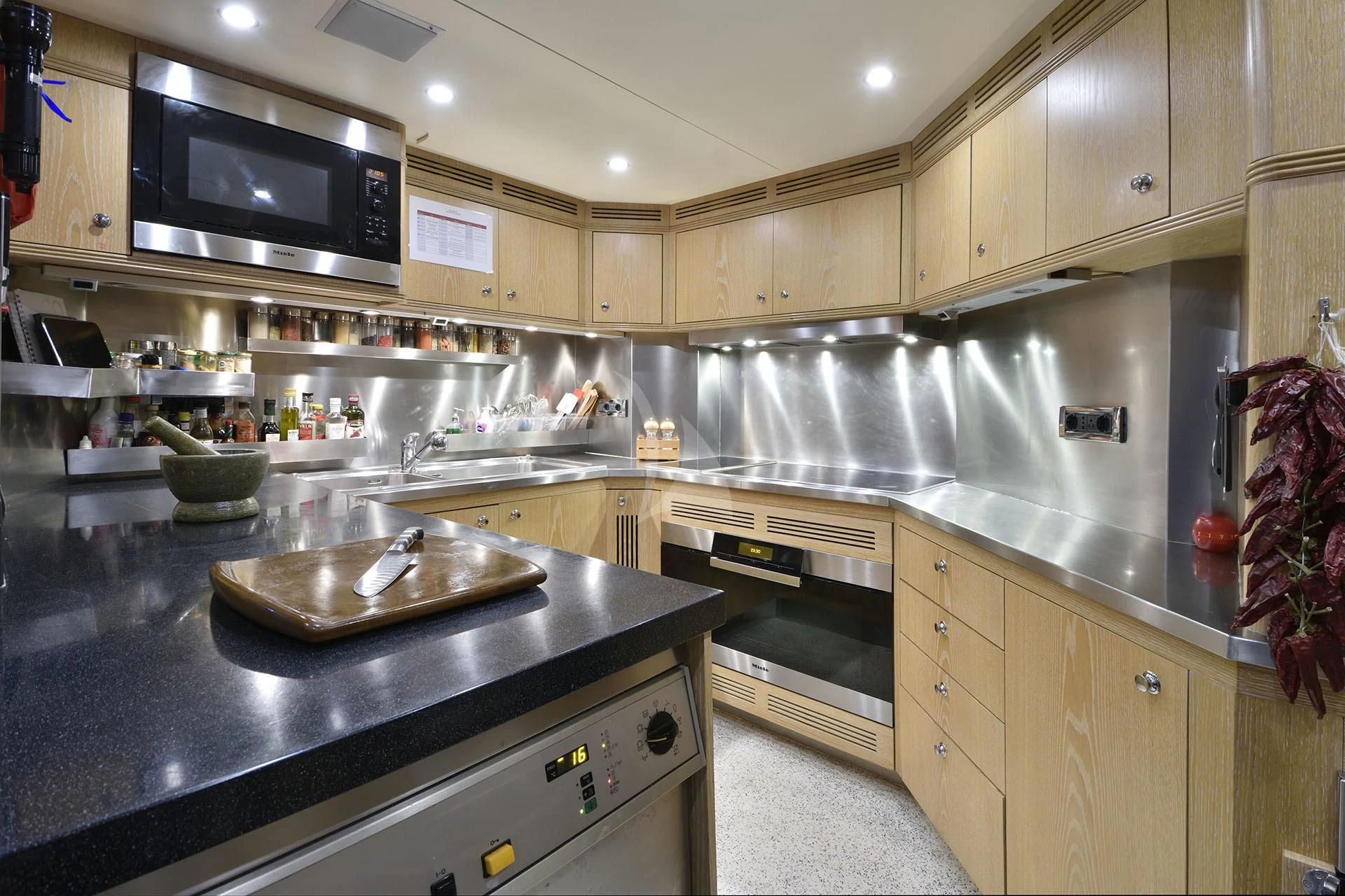 a kitchen with a stove and microwave aboard QUEST R Yacht for Sale