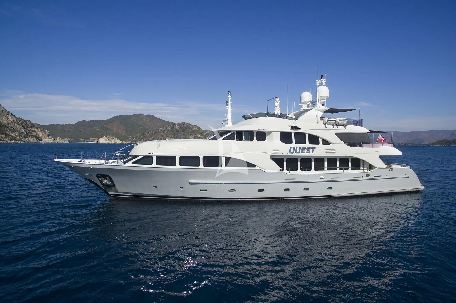a white yacht in the water aboard QUEST R Yacht for Sale