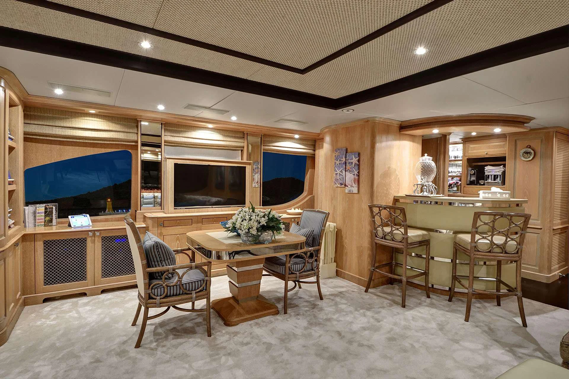 a room with chairs and a table aboard QUEST R Yacht for Sale