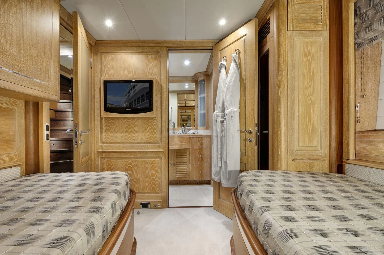 a room with a bed and a television aboard QUEST R Yacht for Sale