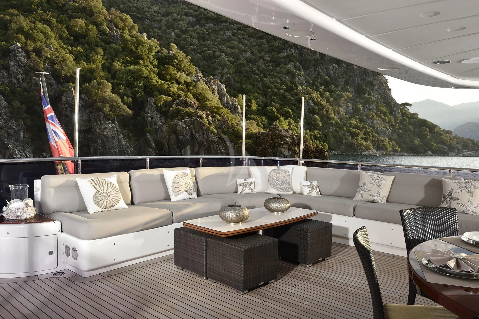 a large living room with a large sofa and a large flag aboard QUEST R Yacht for Sale