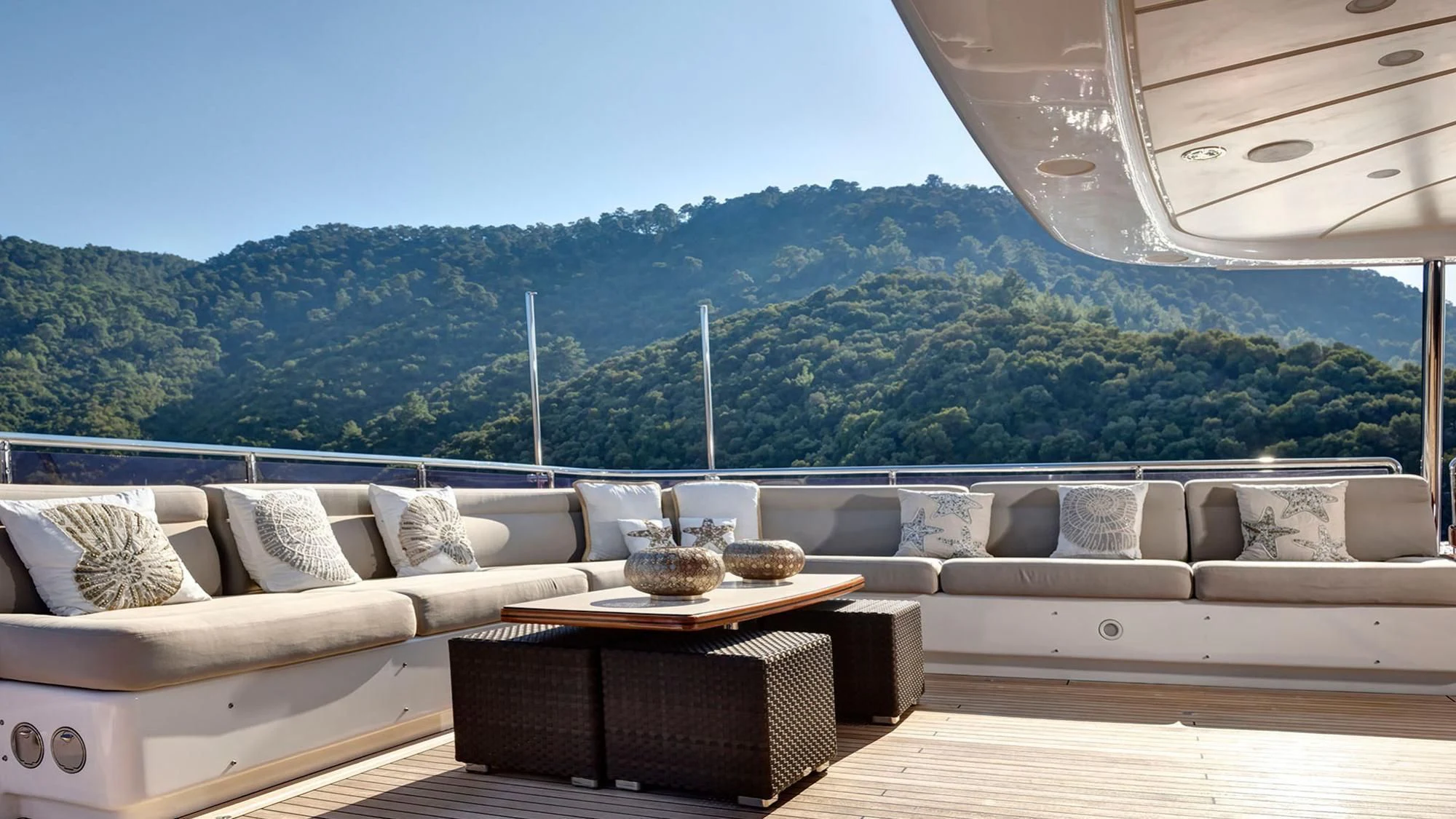 a living room with a large view of mountains and a lake aboard QUEST R Yacht for Sale