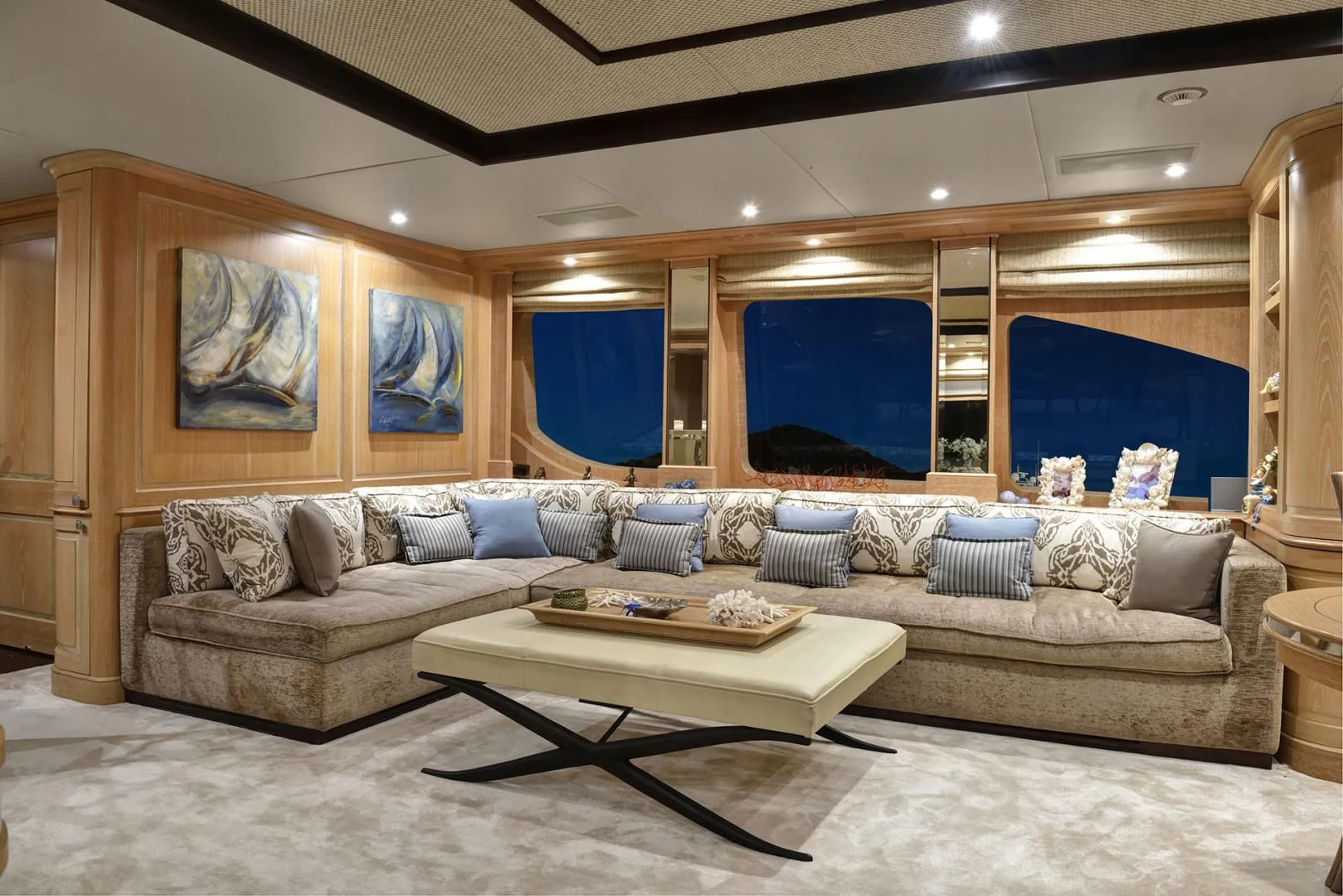 a living room with a large sofa aboard QUEST R Yacht for Sale