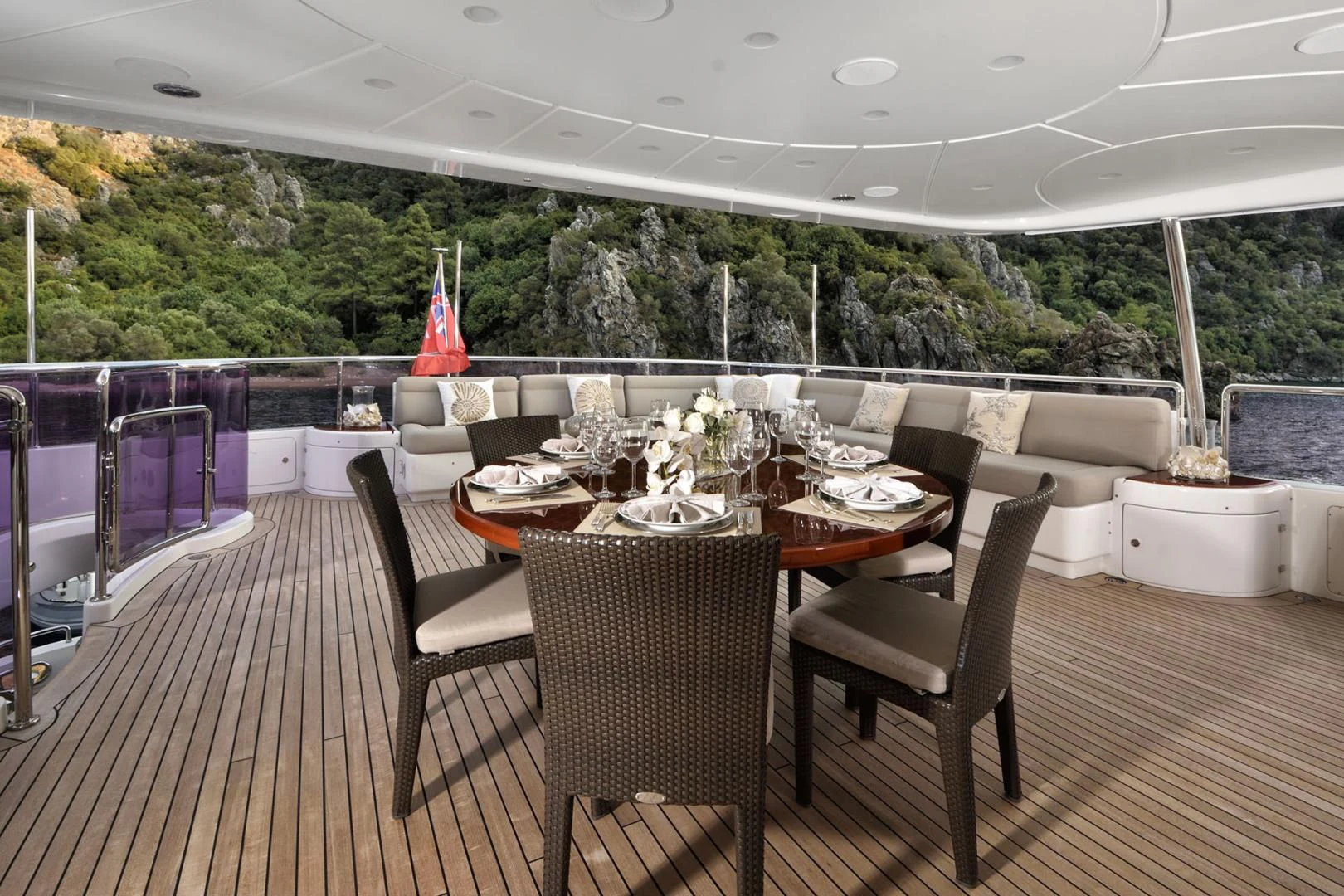 a deck with a table and chairs aboard QUEST R Yacht for Sale