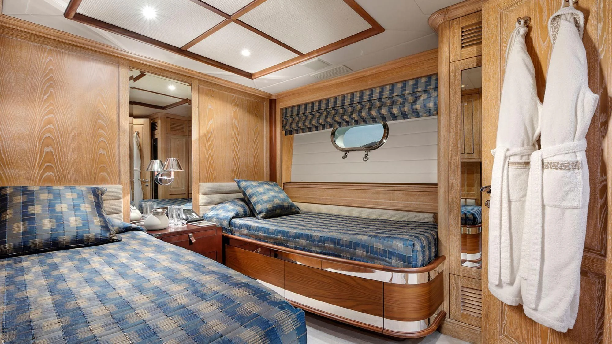 a room with a bed and a mirror aboard QUEST R Yacht for Sale