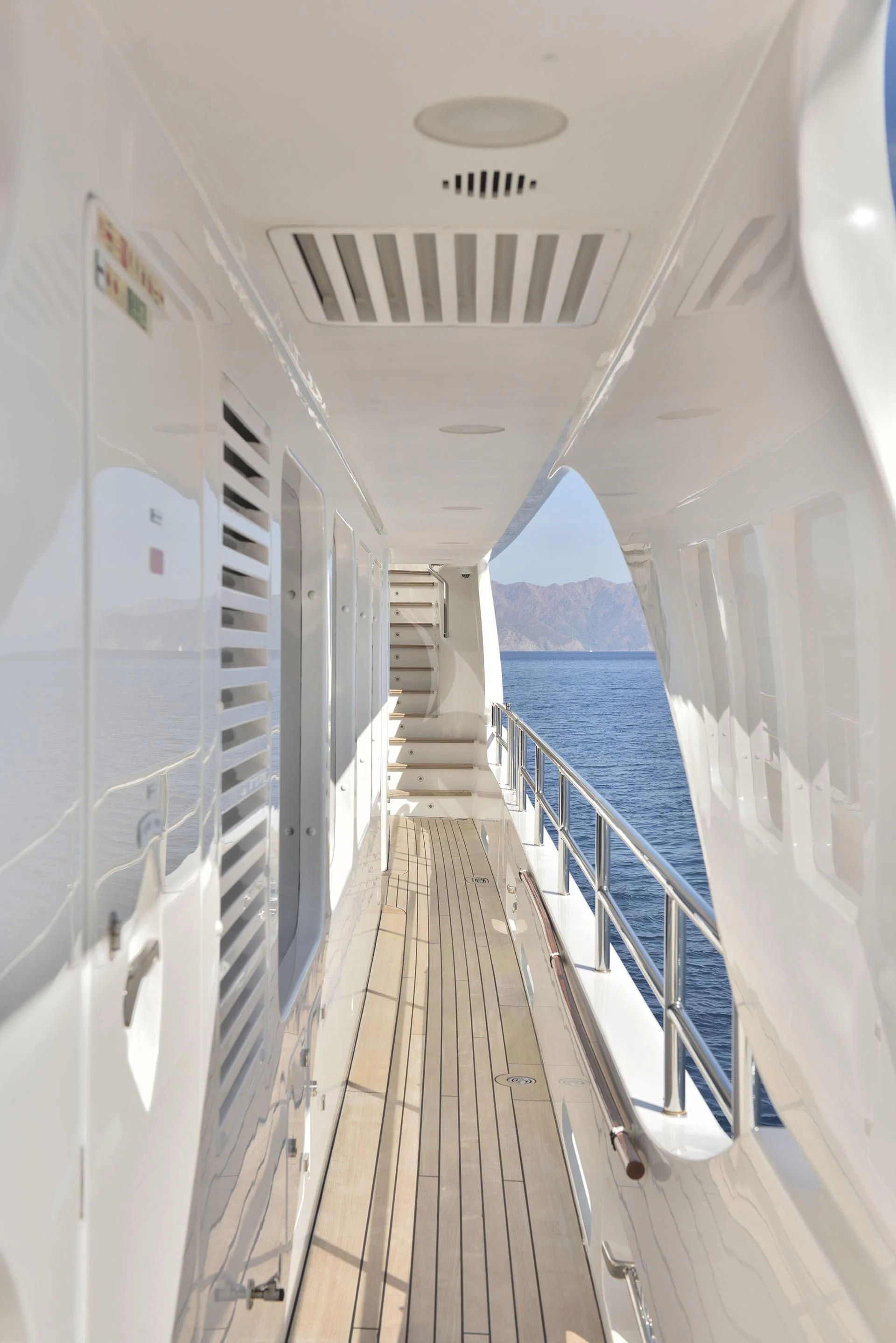 a long hallway with white walls aboard QUEST R Yacht for Sale