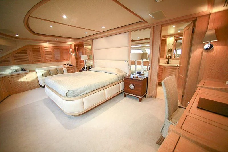 a room with a bed and a chair aboard QUEST R Yacht for Sale