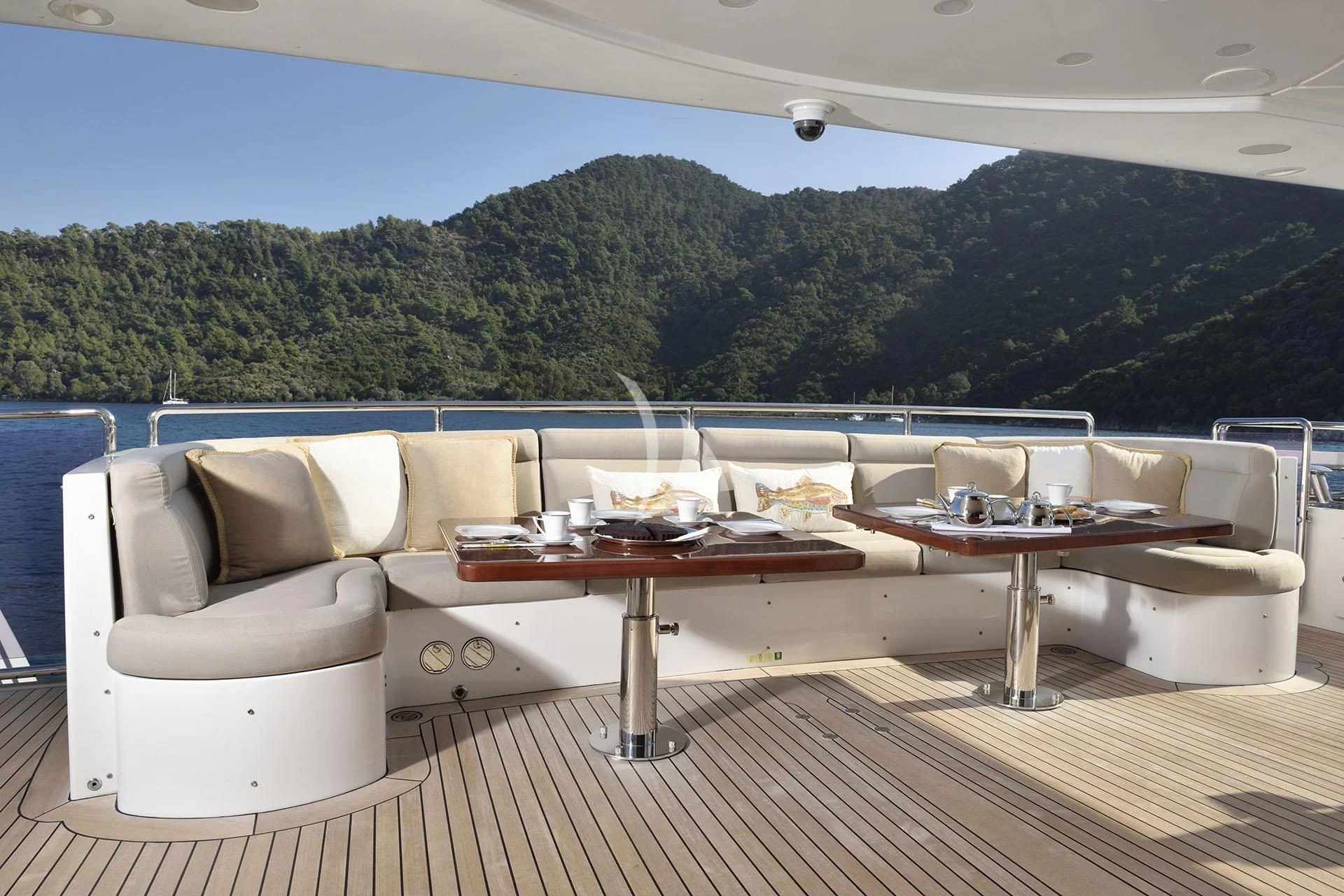 a room with a couch and a table and a large window aboard QUEST R Yacht for Sale