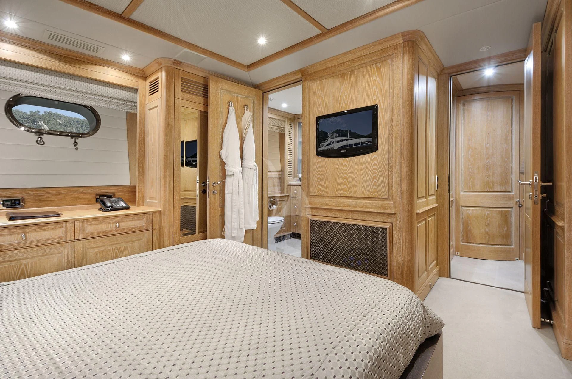 a bedroom with a bed and a television aboard QUEST R Yacht for Sale
