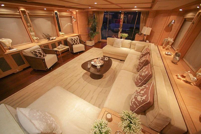 a large living room with a large couch and a table aboard QUEST R Yacht for Sale