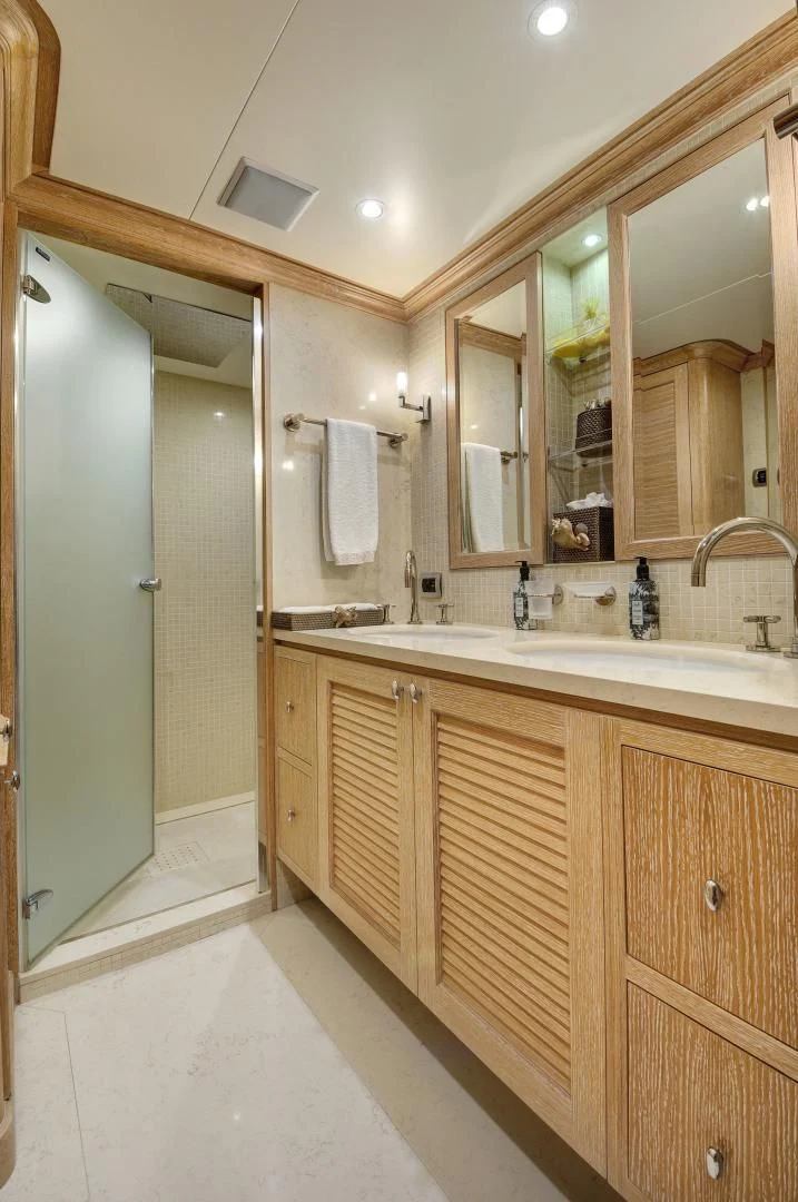 a bathroom with a large mirror aboard QUEST R Yacht for Sale
