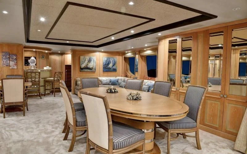 a dining room with a table and chairs aboard QUEST R Yacht for Sale