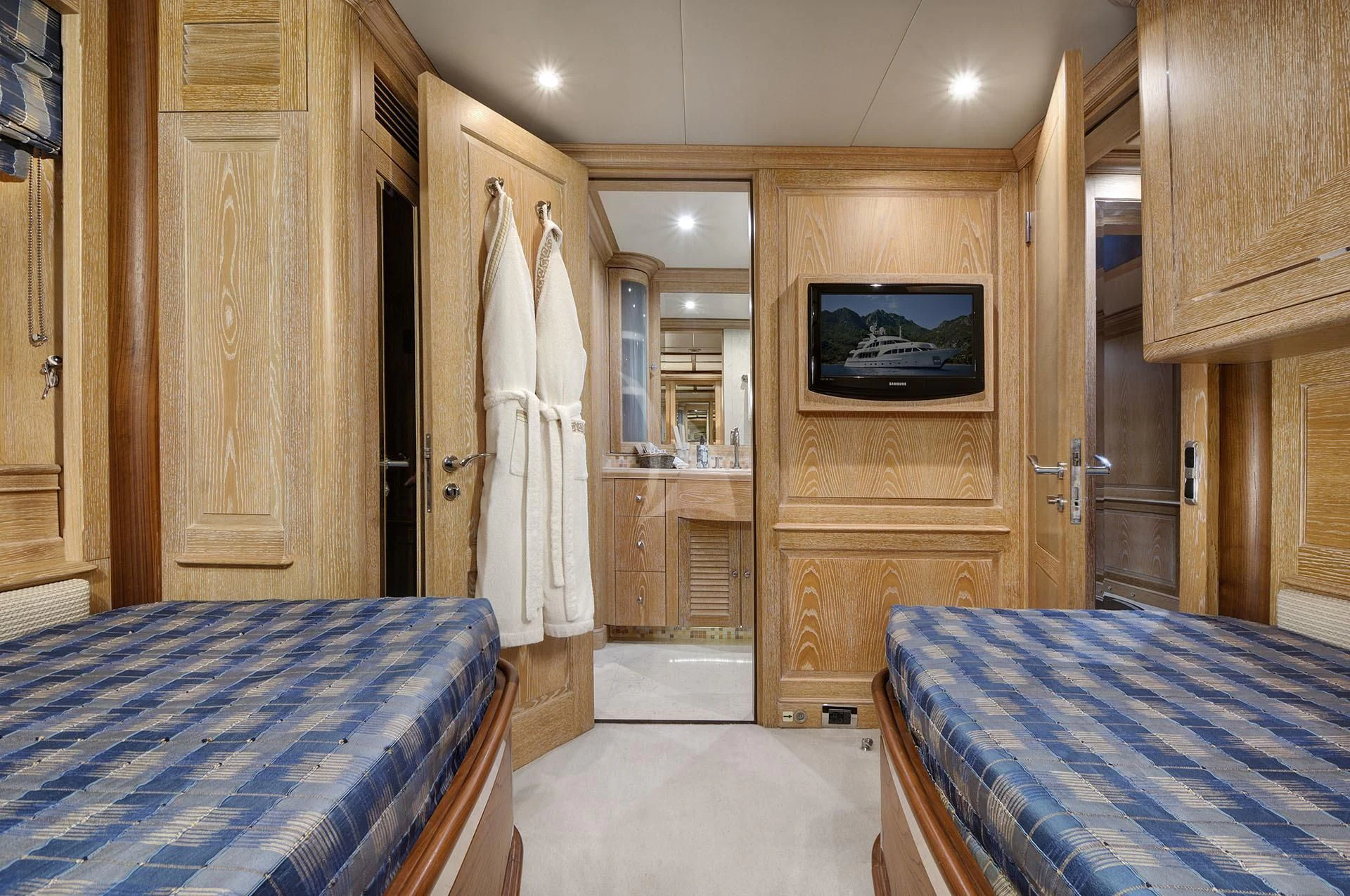 a bedroom with a bed and a closet aboard QUEST R Yacht for Sale