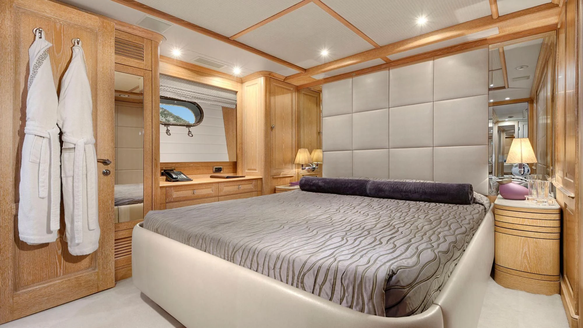 a bedroom with a bed and a mirror aboard QUEST R Yacht for Sale