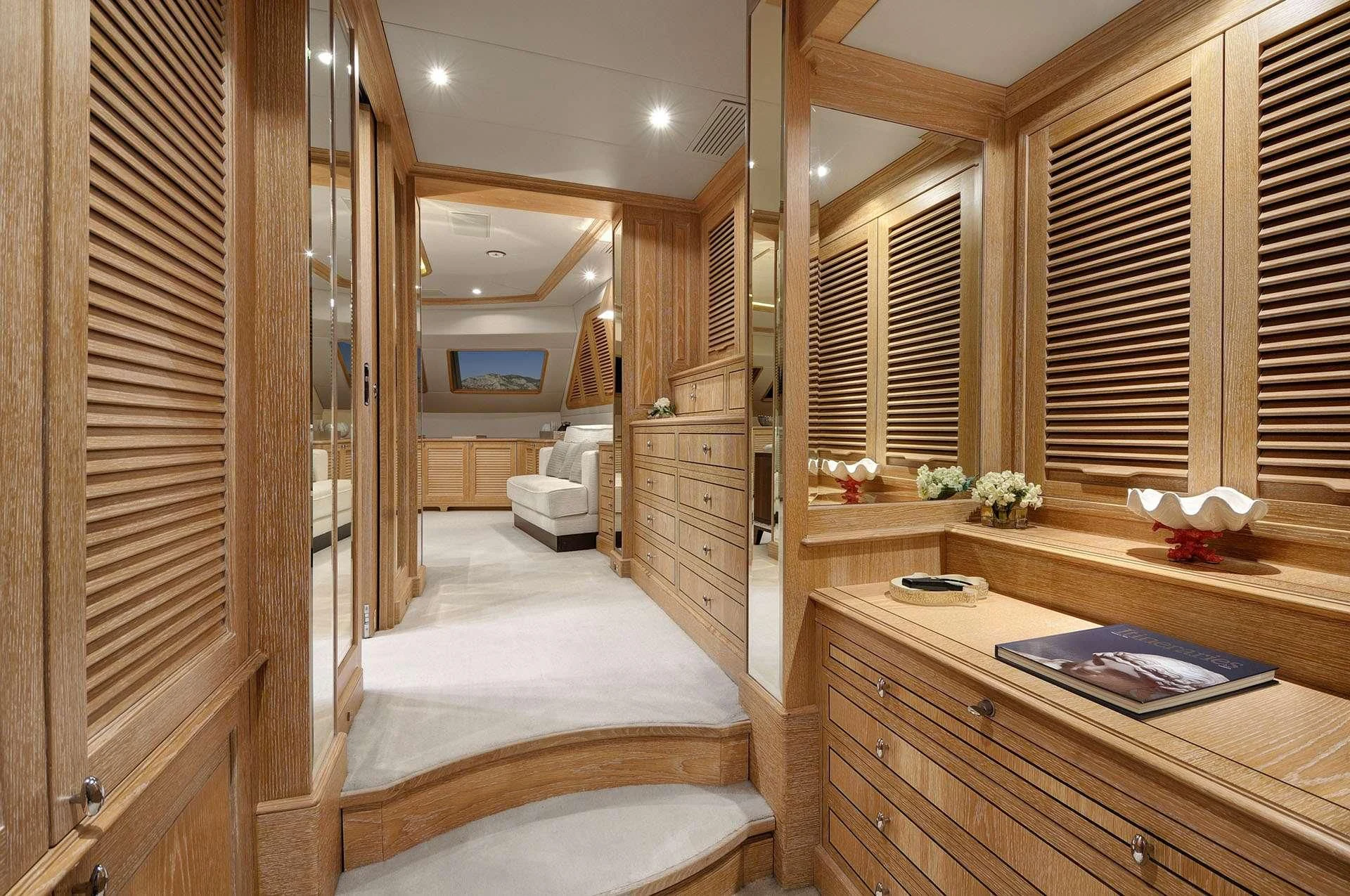 a room with a bed and a desk aboard QUEST R Yacht for Sale