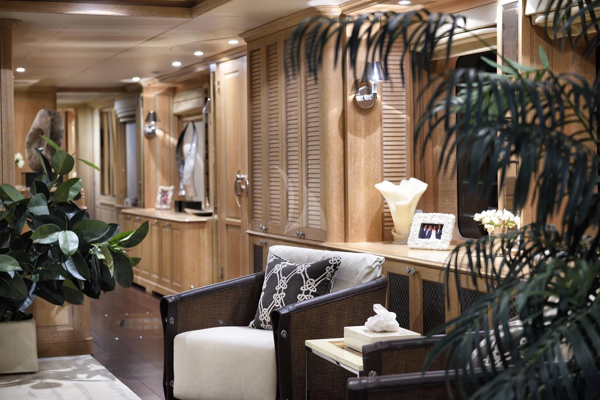 a room with a chair and a table with plants aboard QUEST R Yacht for Sale