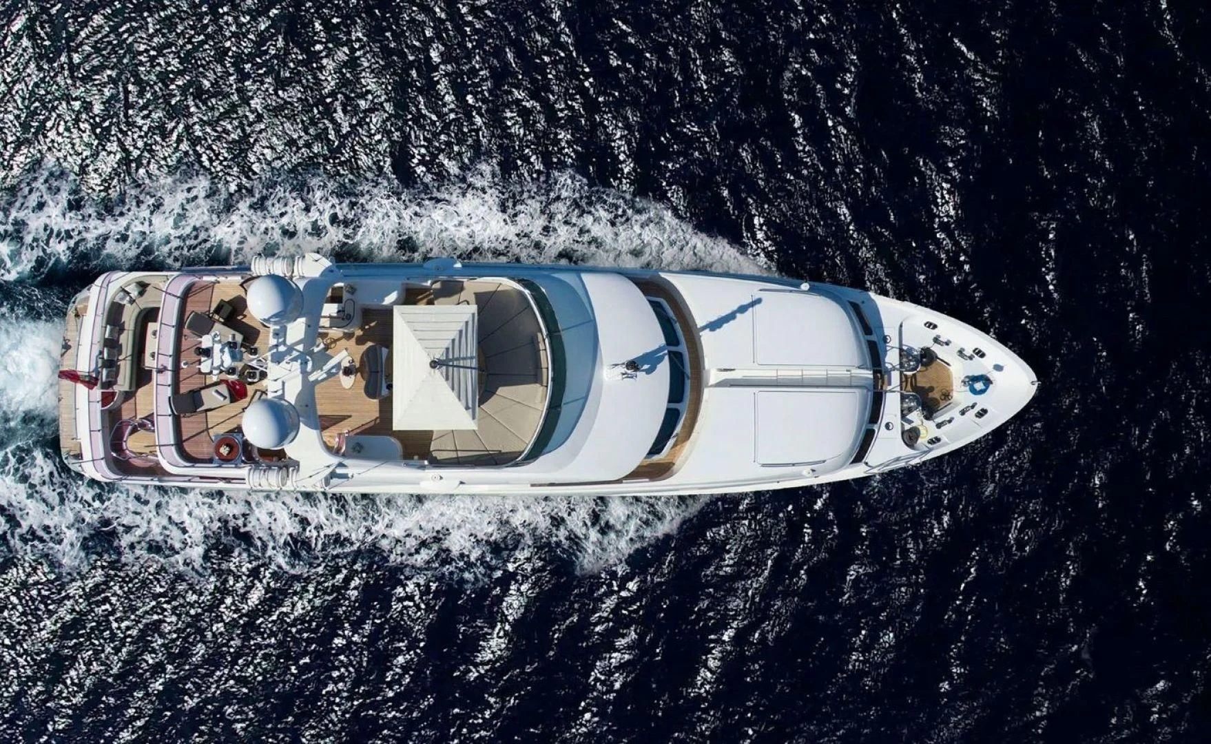 a white and blue vehicle aboard QUEST R Yacht for Sale