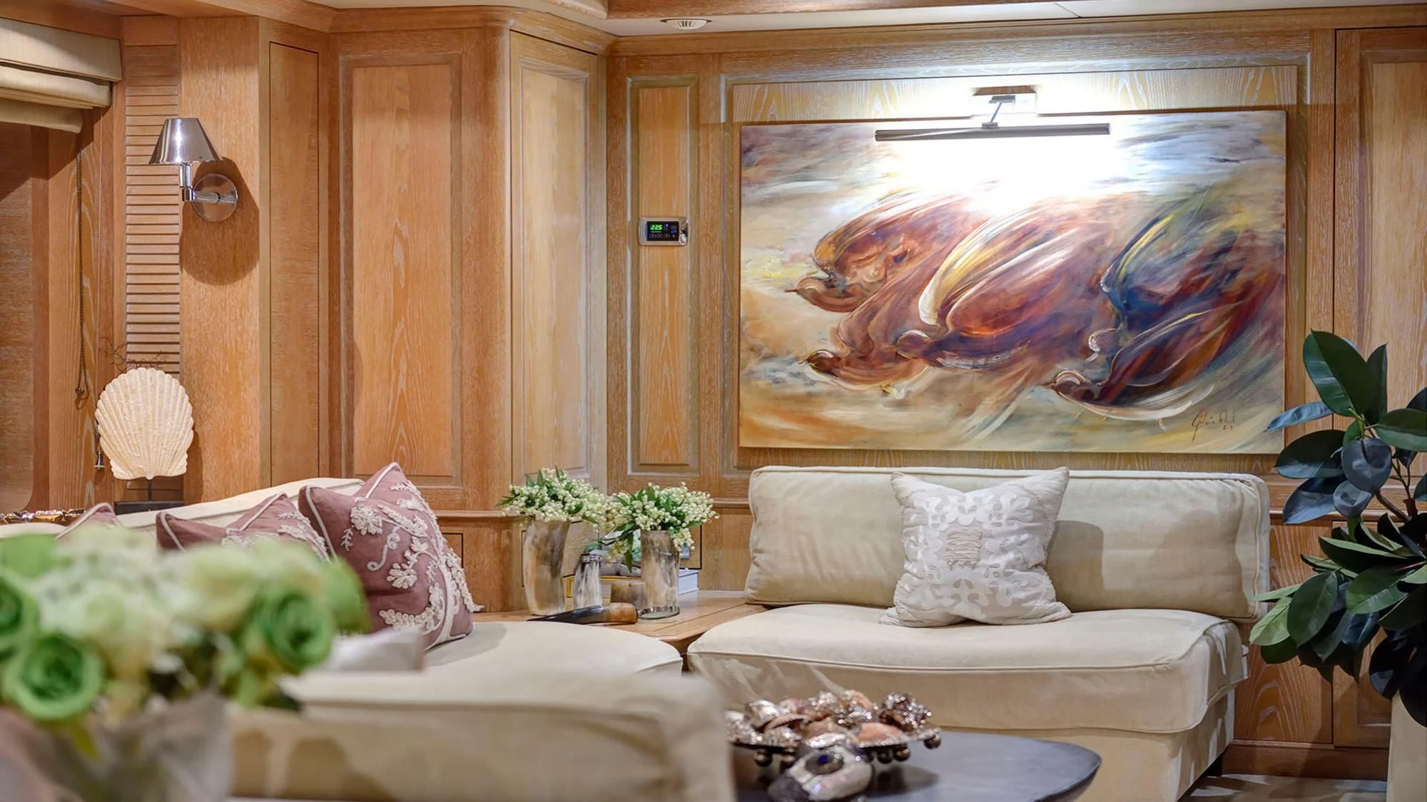 a living room with a painting aboard QUEST R Yacht for Sale