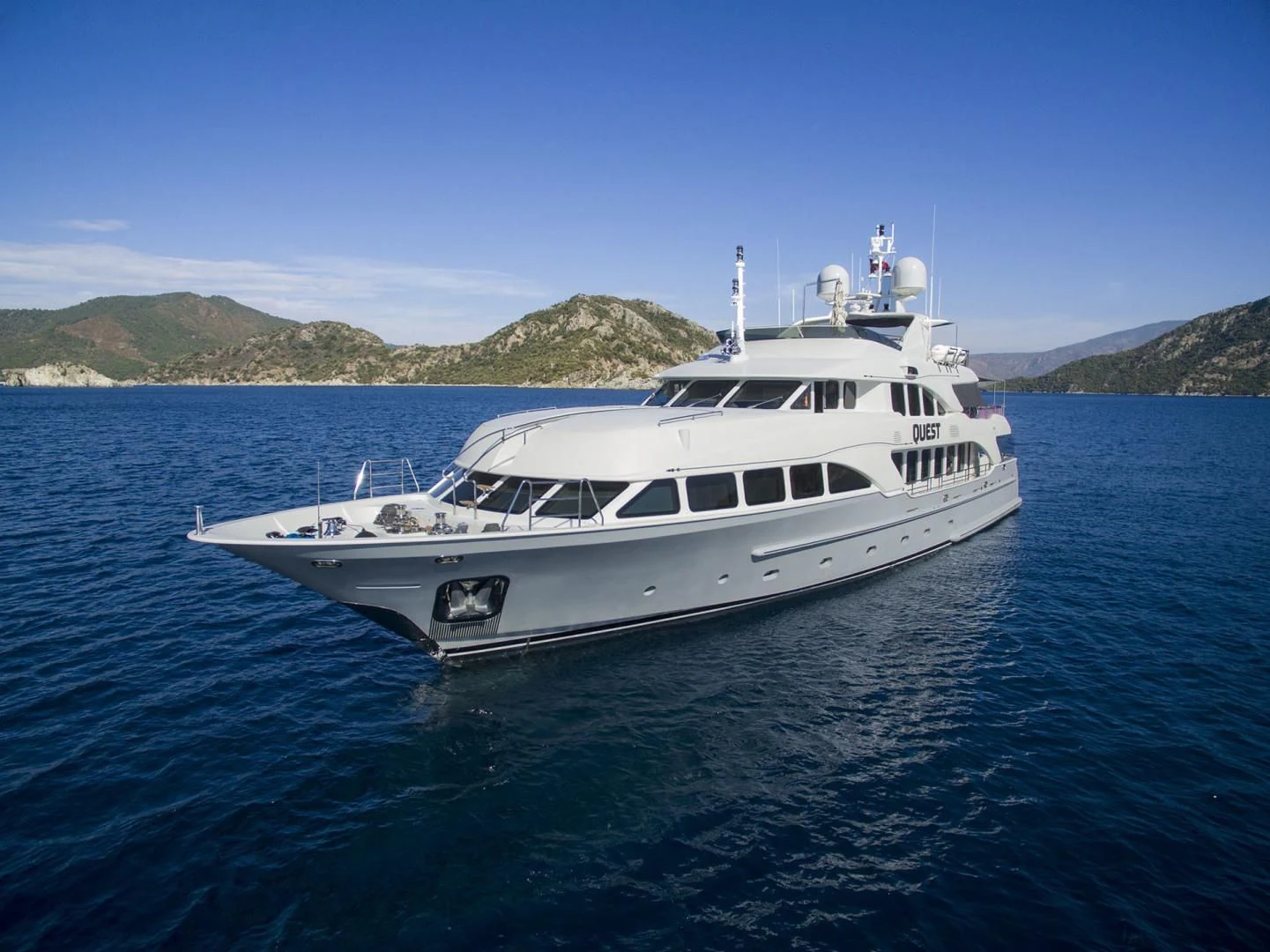 a white yacht in the water aboard QUEST R Yacht for Sale