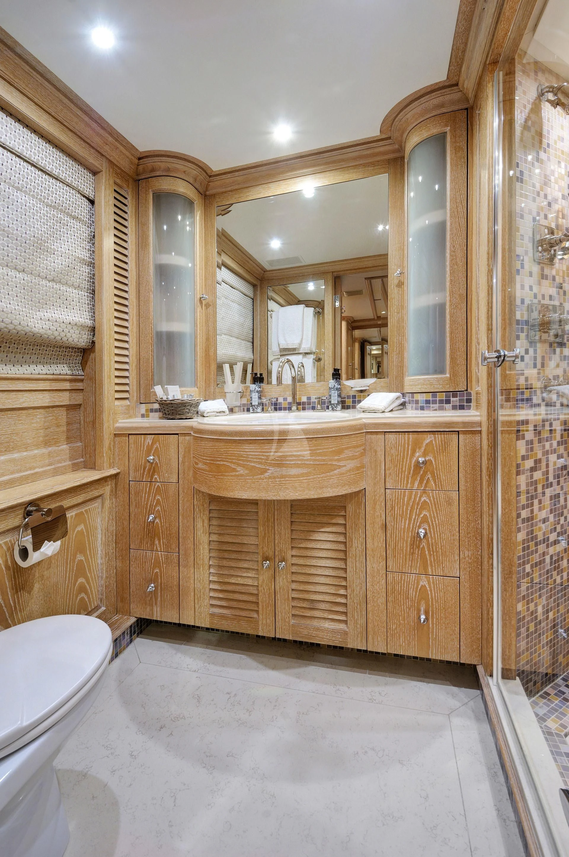 a bathroom with a large mirror aboard QUEST R Yacht for Sale