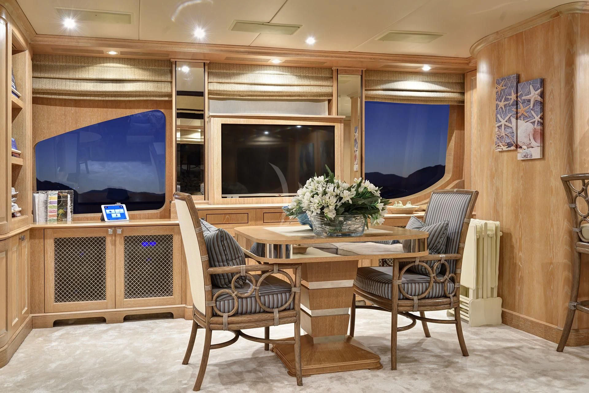 a room with a table and chairs aboard QUEST R Yacht for Sale