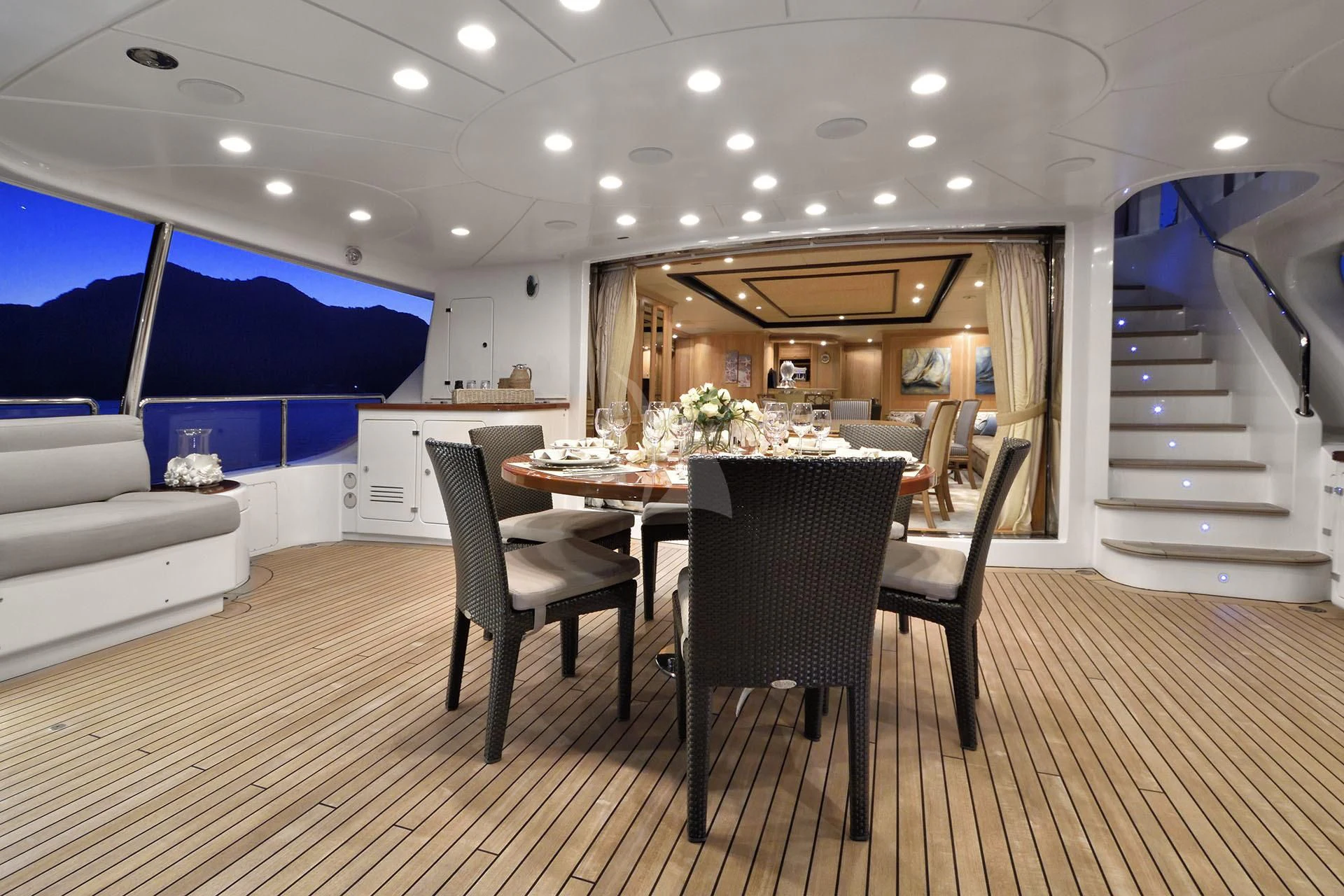a large room with a table and chairs aboard QUEST R Yacht for Sale