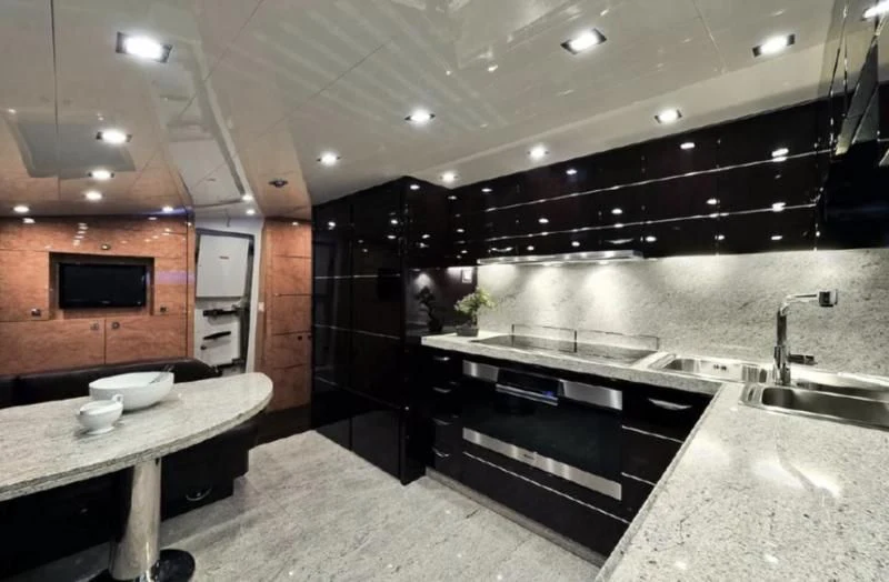 a modern kitchen with marble counters aboard ESCAPE II Yacht for Sale