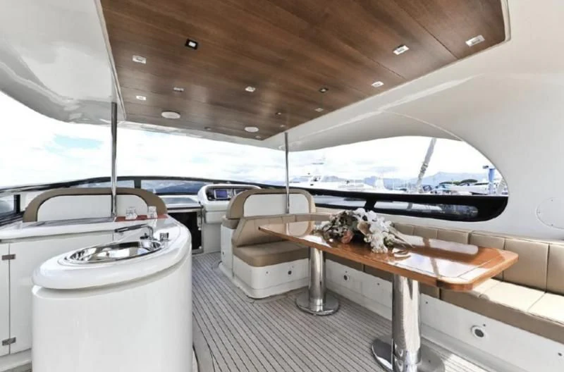 a boat with a table and chairs aboard ESCAPE II Yacht for Sale