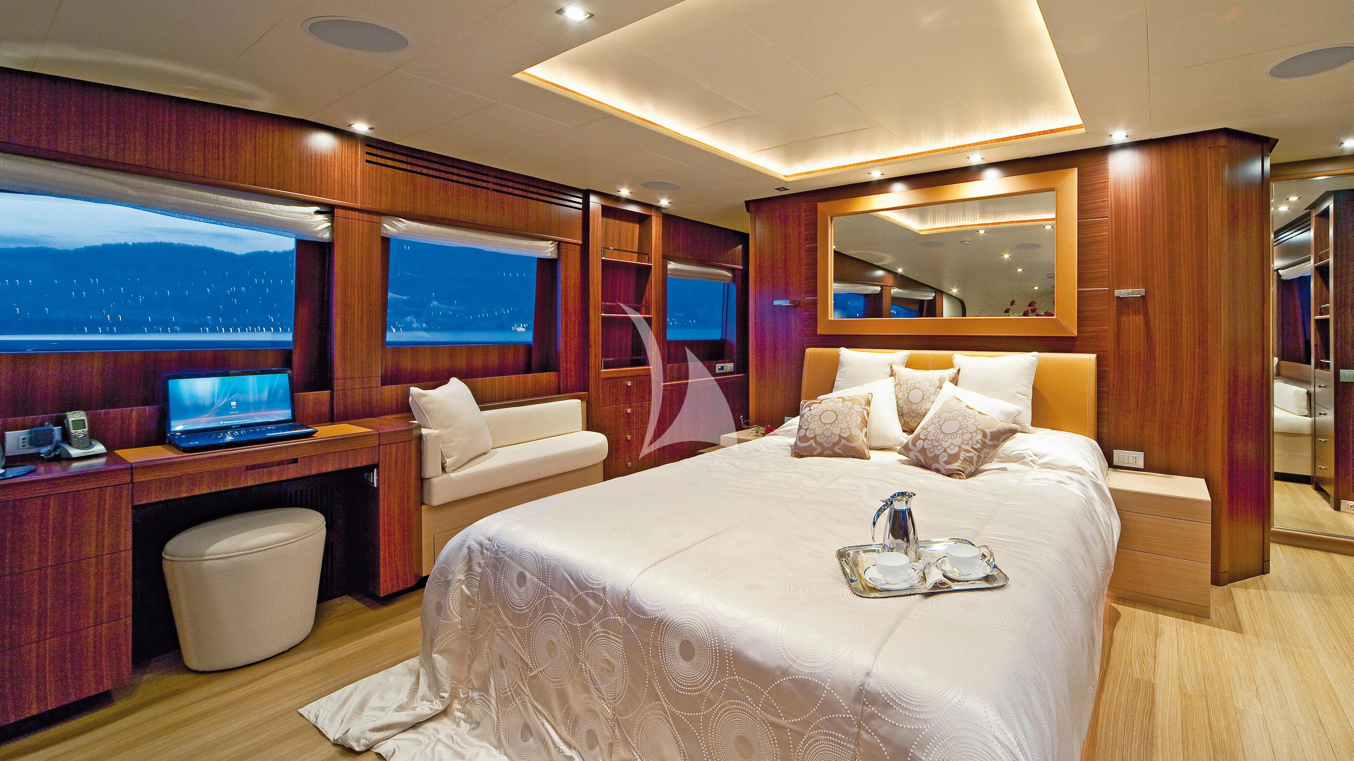a hotel room with a bed and a desk aboard SOIREE Yacht for Sale