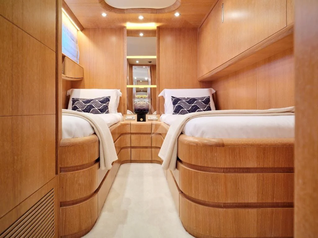 a room with beds and a mirror aboard IRENE'S Yacht for Sale