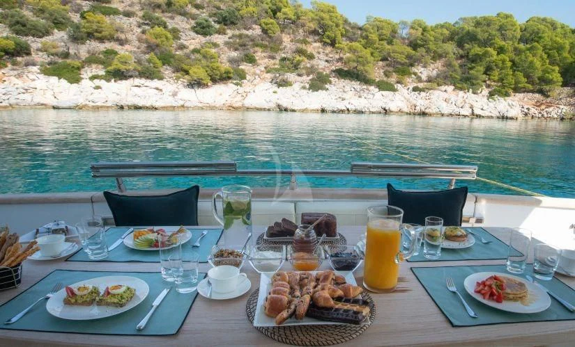a table with food and drinks on it aboard IRENE'S Yacht for Sale