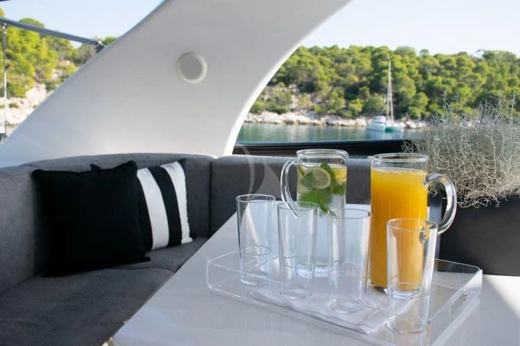 a table with glasses and drinks aboard IRENE'S Yacht for Sale