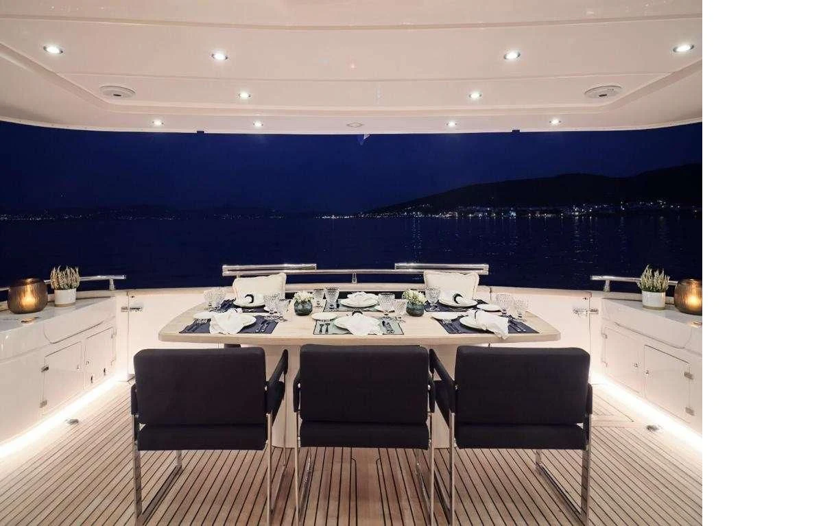 a large kitchen with a large white table and chairs aboard IRENE'S Yacht for Sale
