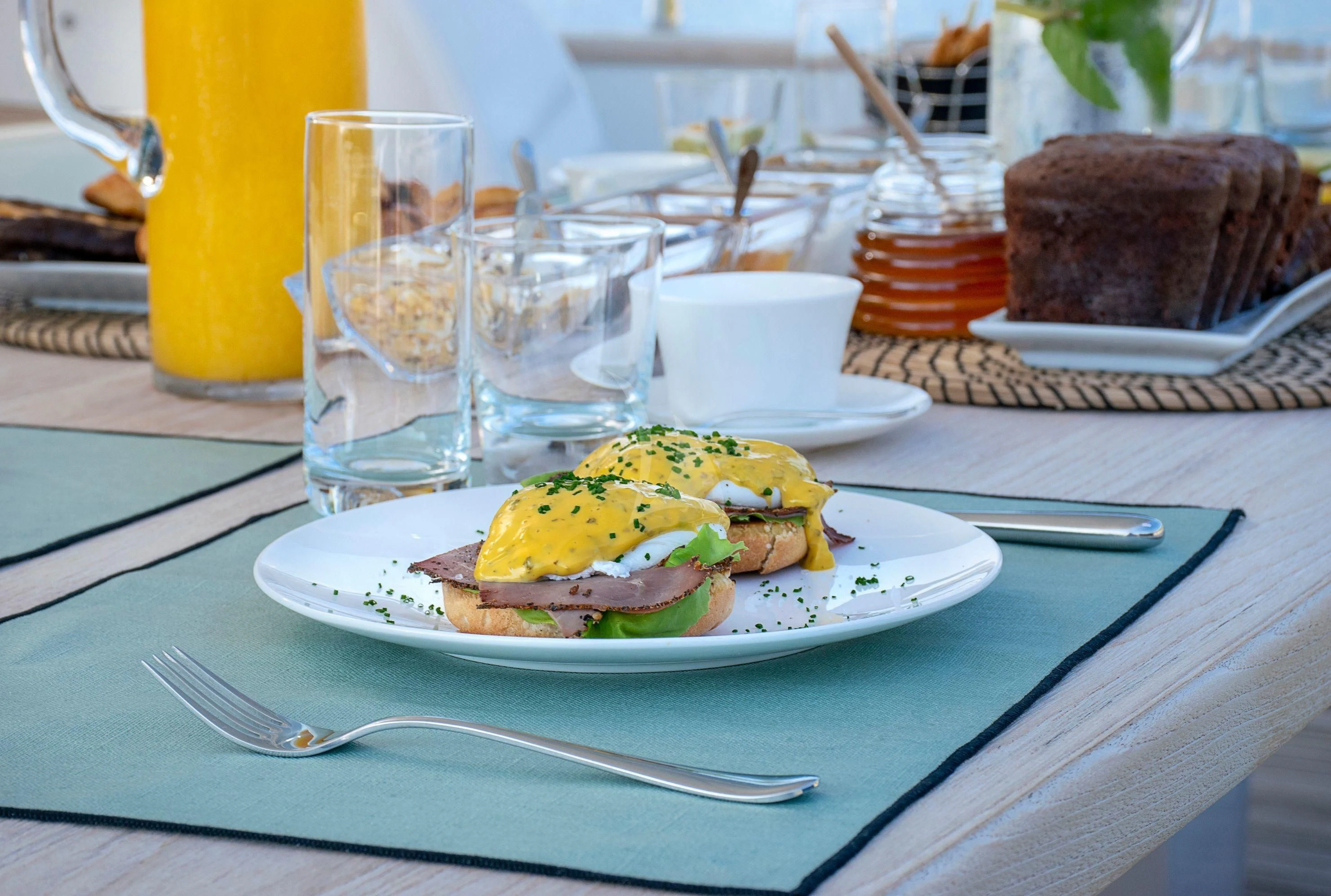 a plate of food and glasses aboard IRENE'S Yacht for Sale