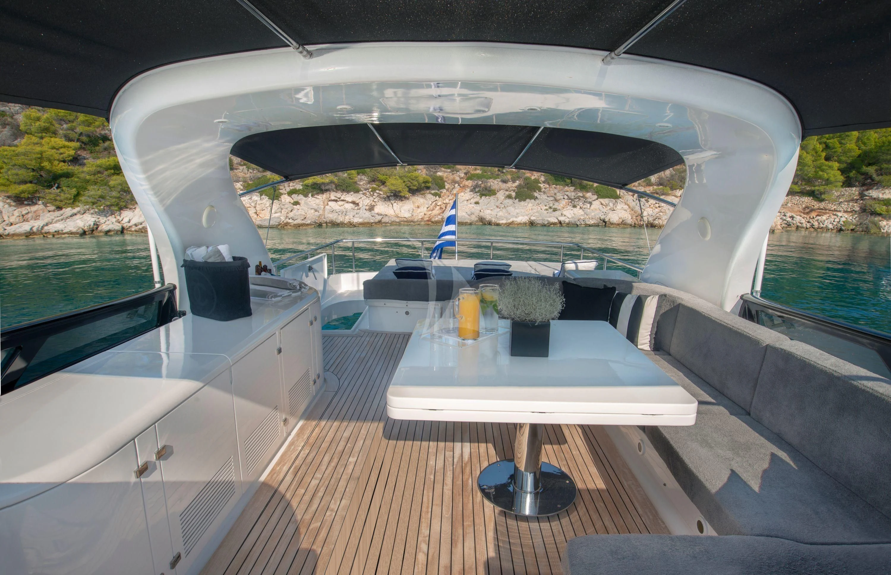 a deck with a table and chairs on it aboard IRENE'S Yacht for Sale