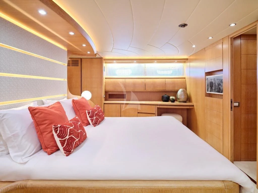 a bed with red pillows aboard IRENE'S Yacht for Sale
