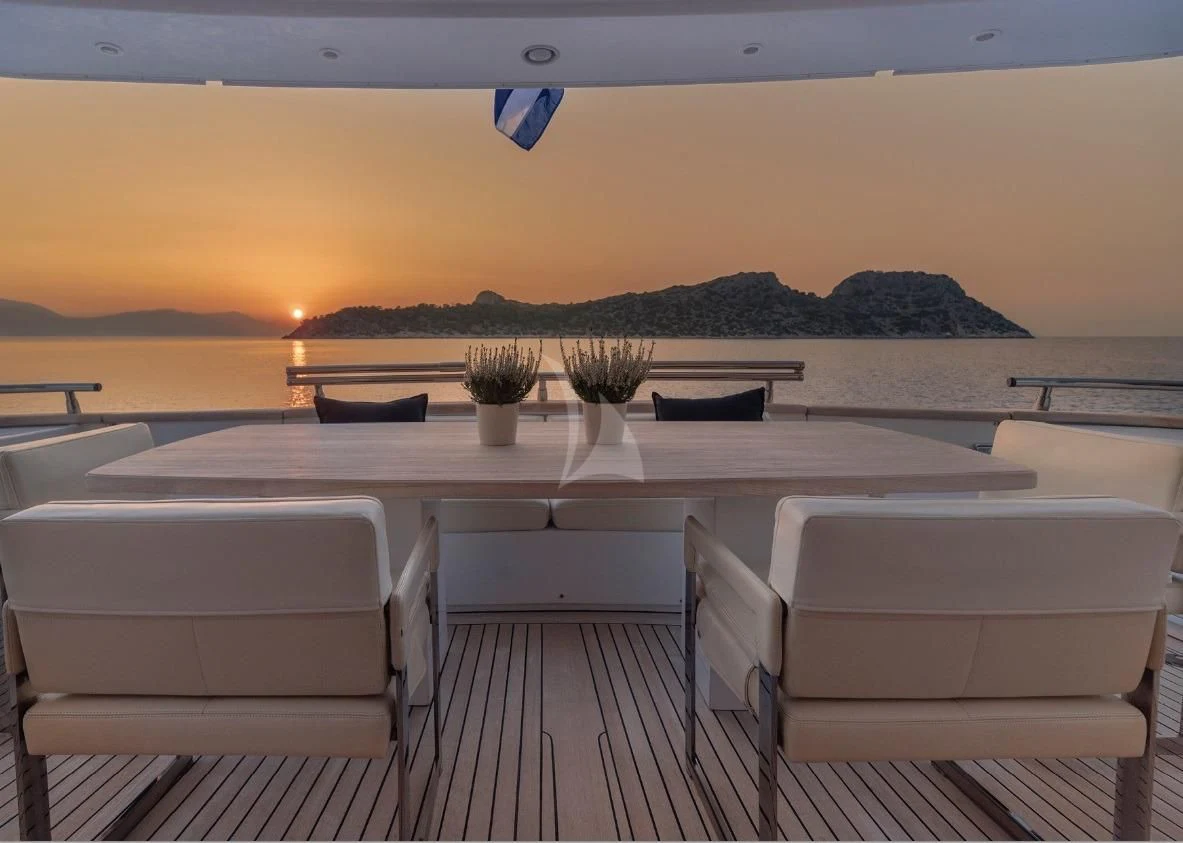 a deck with chairs and a table on it aboard IRENE'S Yacht for Sale
