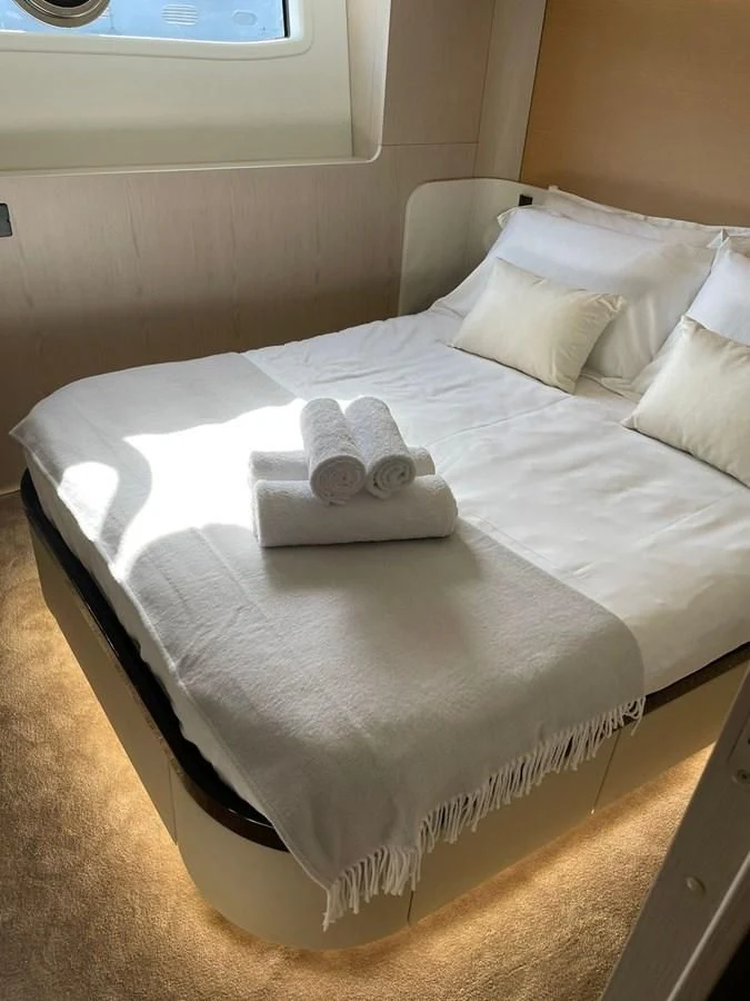 a bed with a white sheet aboard SUN LIFE Yacht for Sale