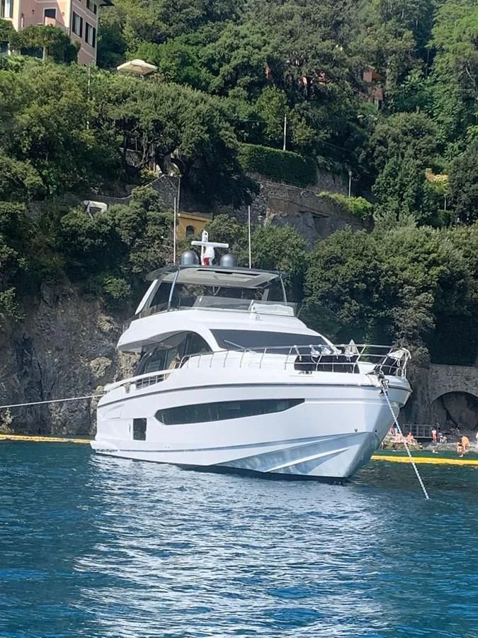 a white boat in a body of water aboard SUN LIFE Yacht for Sale